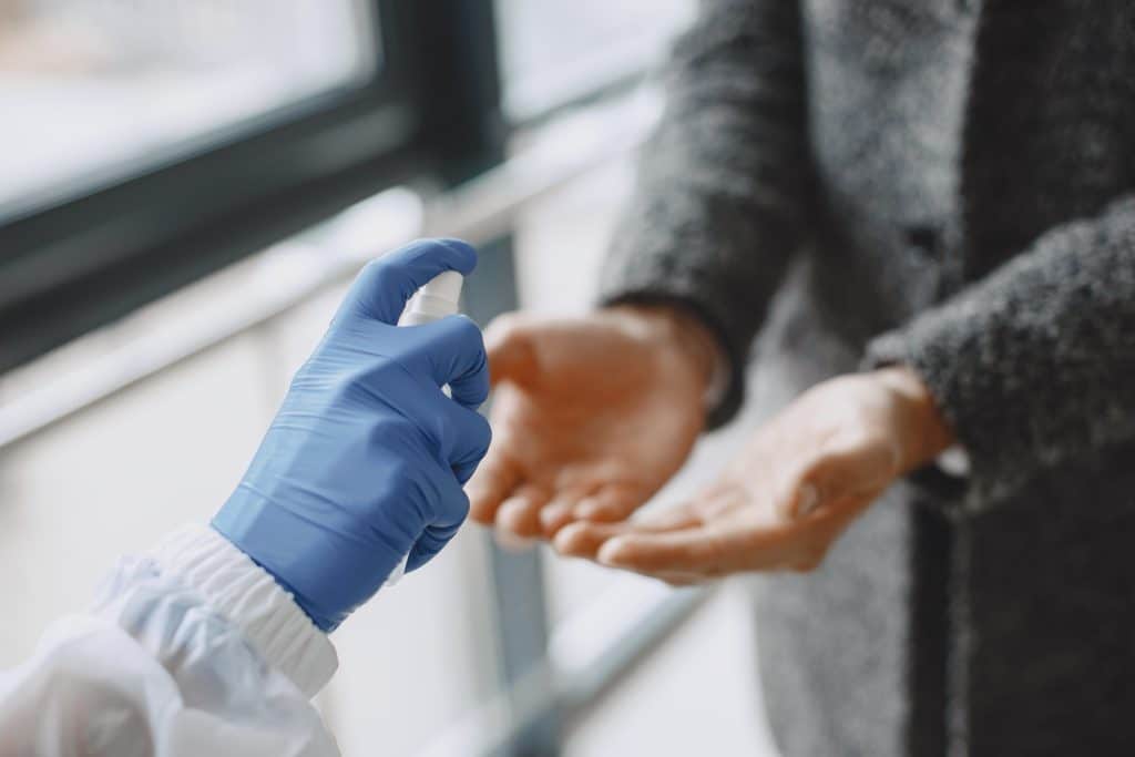 using hand sanitiser and PPE as a method of infection prevention and control