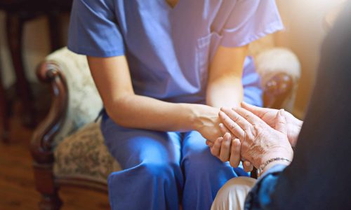 Care Home Training Image - Carer with Care home resident showing hands.