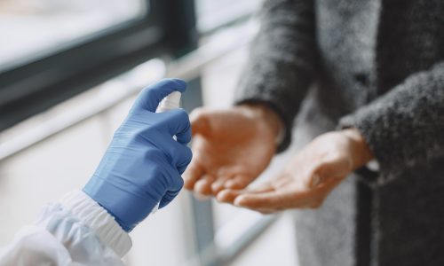 Gloves Spraying Hand Sanitiser using hand sanitiser and PPE as a method of infection prevention and control